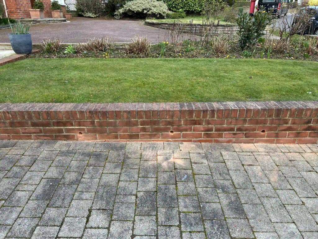 Modern LED wall lights illuminating a driveway in Winchmore Hill