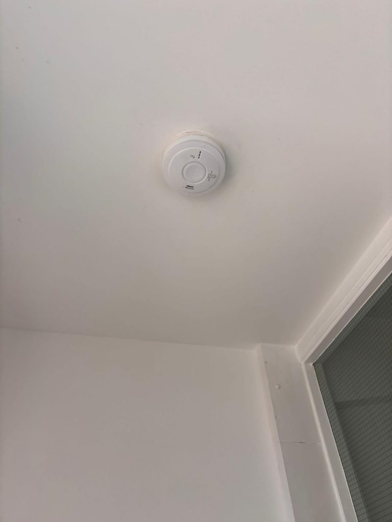 Installation of modern mains smoke alarm in residential property