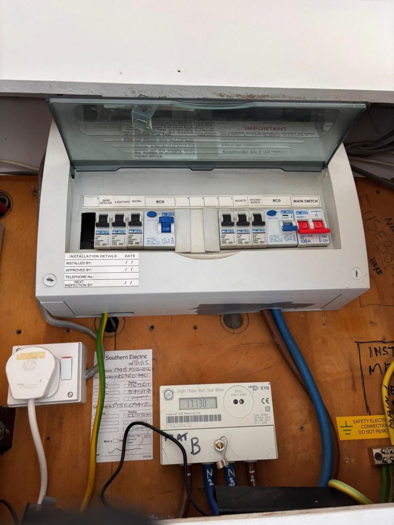 Electrician replacing outdated fuseboard after EICR in London
