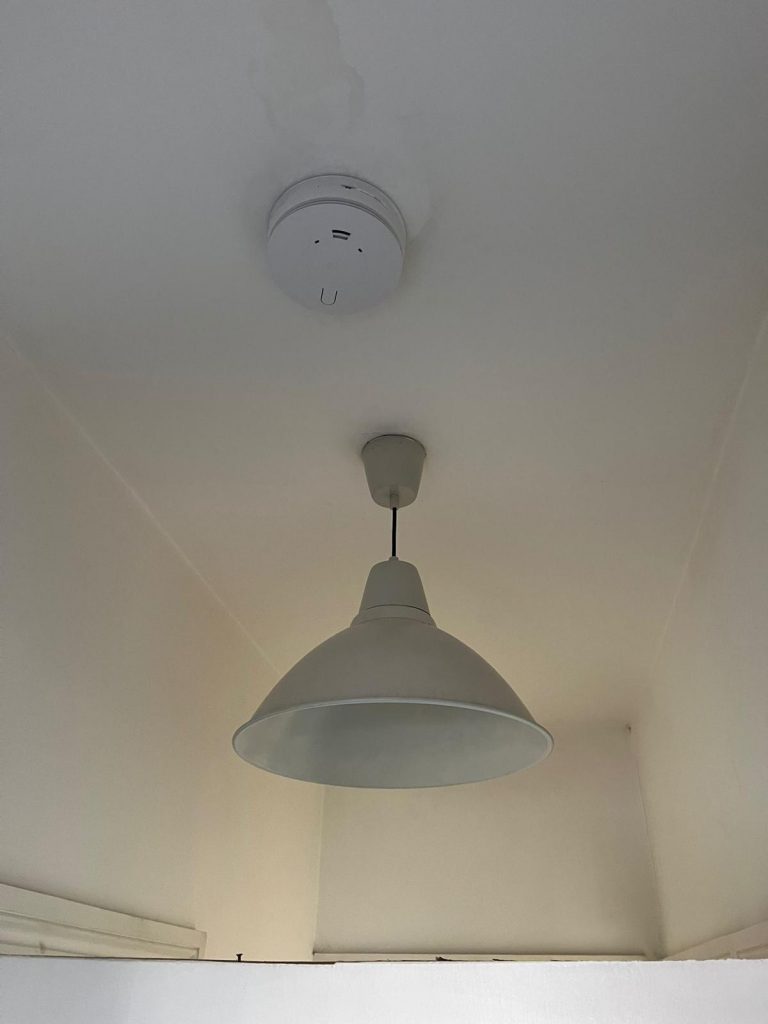 Installation of modern mains smoke alarm in residential property