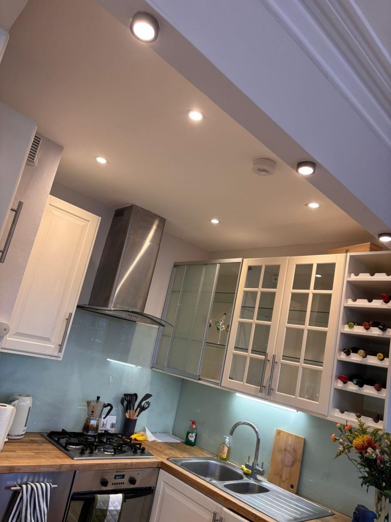 Professional electrician installing new wiring in Islington property