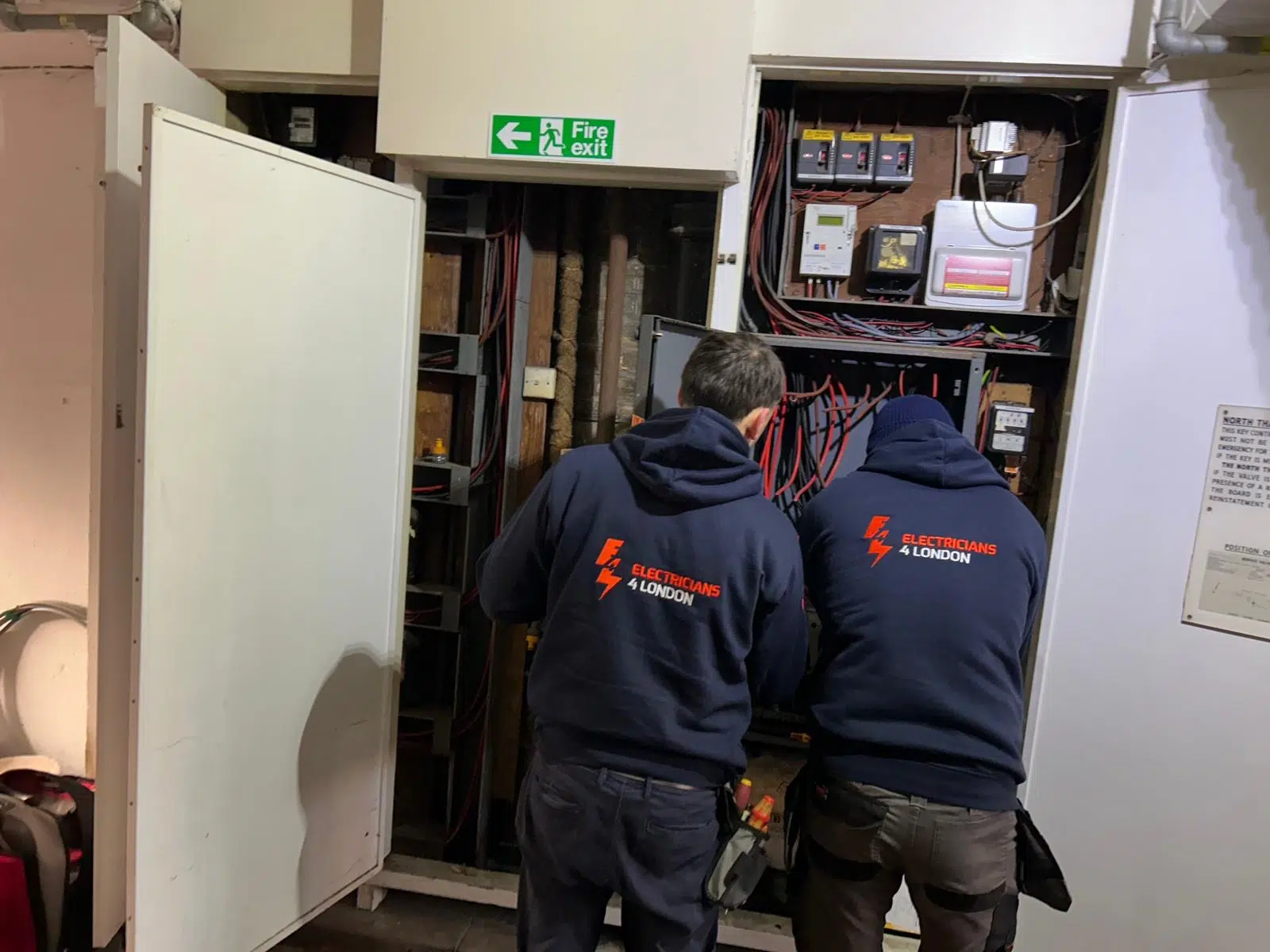 Electrician investigating electrical wiring faults during fault finding work in London