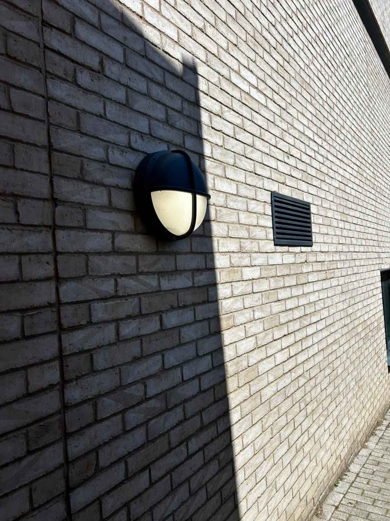 Communal external LED lighting installed along the side of a residential apartment building in Camden Town.