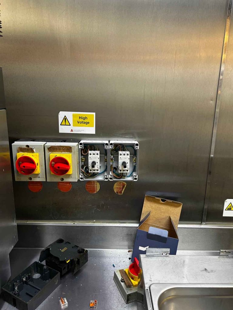Commercial kitchen emergency gas valve and electrical control system in a restaurant in Soho, Central London.