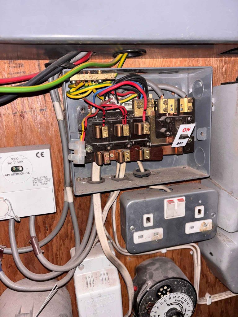 Existing outdated consumer unit at block of flats in Camden Town